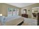 Bedroom featuring large windows, neutral carpet, dresser, and access to the living room at 21214 W Tern Ct, Fort Mill, SC 29707