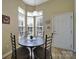 Breakfast nook with a round table, four chairs, and large windows for ample natural light at 21214 W Tern Ct, Fort Mill, SC 29707