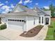 Charming home featuring a two-car garage, manicured landscaping, and inviting front entrance at 21214 W Tern Ct, Fort Mill, SC 29707