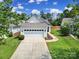 Inviting single-story home with attached garage, green lawn and landscaped entrance at 21214 W Tern Ct, Fort Mill, SC 29707