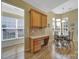 Kitchen/office area with wood cabinets, stainless appliances, desk, and breakfast nook with chairs at 21214 W Tern Ct, Fort Mill, SC 29707