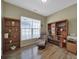 A well-lit room featuring hardwood floors, built-in shelving and a cozy recliner chair at 21214 W Tern Ct, Fort Mill, SC 29707