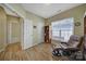 Comfortable living room with wood floors, recliner chair and natural light from a large window at 21214 W Tern Ct, Fort Mill, SC 29707