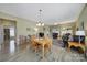 Bright open living area with wood floors, dining table, ceiling fan, and sliding glass doors to the outside at 21214 W Tern Ct, Fort Mill, SC 29707