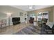 Living room with wood floors, cozy seating area, rug, TV and access to the backyard at 21214 W Tern Ct, Fort Mill, SC 29707