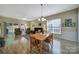 Open living room features wood floors, ceiling fan, large window with blinds, and sliding glass doors to the outside at 21214 W Tern Ct, Fort Mill, SC 29707