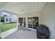 A covered outdoor patio with chairs, a grill, and view of the backyard at 21214 W Tern Ct, Fort Mill, SC 29707