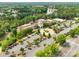 Aerial view of clubhouse, pool, parking and a community surrounded by mature trees and a serene lake at 23117 Whimbrel Cir, Fort Mill, SC 29707