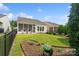 Scenic backyard featuring a neatly mowed lawn, mature landscaping, and a screened-in porch, perfect for entertaining at 23117 Whimbrel Cir, Fort Mill, SC 29707