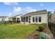 Expansive backyard with lush greenery, manicured gardens, and a charming screened porch, creating a private oasis at 23117 Whimbrel Cir, Fort Mill, SC 29707