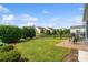 Well-maintained backyard with lush green grass, manicured shrubs, and a black fence offering privacy at 23117 Whimbrel Cir, Fort Mill, SC 29707