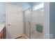 Bathroom showcasing a glass-enclosed shower with white tiling and natural light at 23117 Whimbrel Cir, Fort Mill, SC 29707