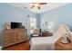 Comfortable bedroom featuring a ceiling fan, natural light, and warm hardwood floors at 23117 Whimbrel Cir, Fort Mill, SC 29707