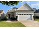 Charming single-story home featuring a two-car garage, well-maintained lawn, and inviting front entrance at 23117 Whimbrel Cir, Fort Mill, SC 29707