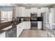 Well-lit kitchen features stainless steel appliances, granite countertops, and tile backsplash at 23117 Whimbrel Cir, Fort Mill, SC 29707