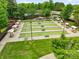 Wide angle aerial view showcasing lush lawn bowling area with benches, shelters, and landscaped surroundings in the community at 23117 Whimbrel Cir, Fort Mill, SC 29707