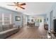 Open-concept living room and dining area featuring hardwood floors and a view into the kitchen at 23117 Whimbrel Cir, Fort Mill, SC 29707
