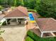 Overhead shot displays shuffleboard courts and covered patio area within a wooded community at 23117 Whimbrel Cir, Fort Mill, SC 29707