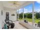 Enclosed sunroom with tiled floor, ceiling fan and views of the green backyard offers a tranquil space at 23117 Whimbrel Cir, Fort Mill, SC 29707