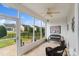 Relaxing screened-in sunroom with wicker furniture and serene views of the fenced backyard, perfect for enjoying the outdoors at 23117 Whimbrel Cir, Fort Mill, SC 29707