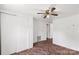 An empty bedroom with plain white walls and carpeting features a ceiling fan and a closet at 2742 Flat Creek Rd, Lancaster, SC 29720