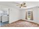 Cozy bedroom featuring a ceiling fan, neutral walls, and a view into the laundry room at 2742 Flat Creek Rd, Lancaster, SC 29720