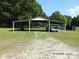 View of the carport with vehicles parked in it on a sunny day at 2742 Flat Creek Rd, Lancaster, SC 29720