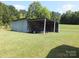 View of the outbuilding with a trailer parked inside it at 2742 Flat Creek Rd, Lancaster, SC 29720