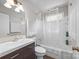 Well-lit bathroom features a shower-tub combo with dark wood cabinets and a modern sink at 309 Ackert Ave, Salisbury, NC 28144
