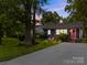Charming gray home featuring a vivid pink front door, a well-kept lawn, and a paved driveway at 309 Ackert Ave, Salisbury, NC 28144