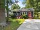 Charming home with a gray exterior, well-manicured lawn, a driveway, and a vibrant pink front door at 309 Ackert Ave, Salisbury, NC 28144