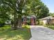 Attractive gray house with a vibrant pink front door, complemented by a lush green lawn and a driveway at 309 Ackert Ave, Salisbury, NC 28144