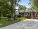 Charming gray house with a well-kept lawn, a long driveway, and a standout pink front door at 309 Ackert Ave, Salisbury, NC 28144