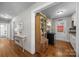 Hallway view leading to a bright kitchen with vintage cabinetry and hardwood floors at 309 Ackert Ave, Salisbury, NC 28144