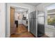 Kitchen with stainless steel refrigerator, white cabinets and vintage hardwood flooring at 309 Ackert Ave, Salisbury, NC 28144