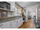 Bright kitchen featuring white cabinets, a stainless steel sink, and hardwood floors at 309 Ackert Ave, Salisbury, NC 28144