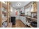 Bright kitchen with white cabinets, a window, and hardwood floors, creating a charming space at 309 Ackert Ave, Salisbury, NC 28144