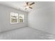 Bright bedroom with neutral carpet, ceiling fan, and natural light from the large double window at 3124 Beacon Heights Rd, Indian Land, SC 29707