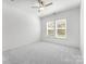 Cozy bedroom with carpet flooring, a ceiling fan, and a window allowing plenty of natural light at 3124 Beacon Heights Rd, Indian Land, SC 29707