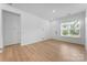 Open-concept living room with hardwood floors and large windows, creating a bright and inviting space at 3124 Beacon Heights Rd, Indian Land, SC 29707