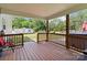 Covered back porch with wood flooring, overlooking the backyard and surrounding trees at 3401 Shillinglaw Rd, Sharon, SC 29742