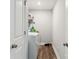 Laundry room with a white washer and dryer, storage space, and wood-look floors at 3401 Shillinglaw Rd, Sharon, SC 29742