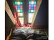 An attic space with a bed setup and colorful stained glass window at 425 W Horah St, Salisbury, NC 28144