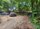 Overgrown backyard with parking spot. Brick home with wood fence at 425 W Horah St, Salisbury, NC 28144