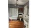 Vintage bathroom with clawfoot tub, pedestal sink, and wood accents at 425 W Horah St, Salisbury, NC 28144