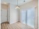 Bright dining area featuring a sliding glass door to the backyard and modern lighting at 463 Delta Dr, Fort Mill, SC 29715