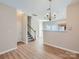 Spacious open-concept living space with hardwood floors, staircase, and dining area chandelier at 463 Delta Dr, Fort Mill, SC 29715