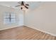 Bright living room with hardwood floors, neutral paint, large window, and a ceiling fan at 463 Delta Dr, Fort Mill, SC 29715