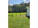 Spacious backyard with green grass and wooden post fencing, providing a serene and private outdoor space at 490 S Moose Rd, Mount Pleasant, NC 28124
