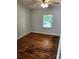 Cozy bedroom featuring hardwood floors and a window overlooking the outdoors, creating a serene space at 490 S Moose Rd, Mount Pleasant, NC 28124